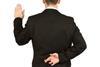 Man swearing oath with fingers crosed