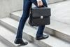 Business man with brief case steps