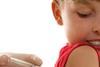 Child having an injection in the arm