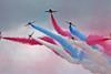 red arrows air display team with red, white and blue tail smoke all over the place
