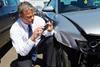 Loss Adjuster Inspecting Car Involved In Accident