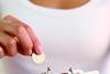 woman putting coin into red purse