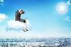 man sitting on cloud laptop