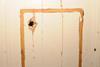 Essex police photo of shotgun damage at insurance executive's home