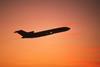Plane against a red sky