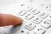 finger on telephone key pad