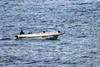 Small boat with hooded men on board