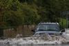 car in water on flooded road