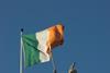 Irish flag above a statue