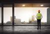 construction worker looking out high rise