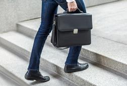 Business man with brief case steps