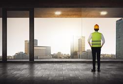 construction worker looking out high rise