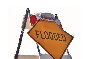 Flooded sign with sandbag