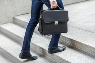 Business man with brief case steps