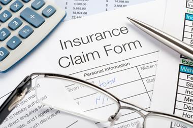 Handwritten Insurance Claim Form with pen and calculator