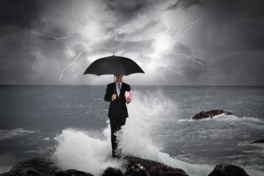 business man in sea storm piggy bank