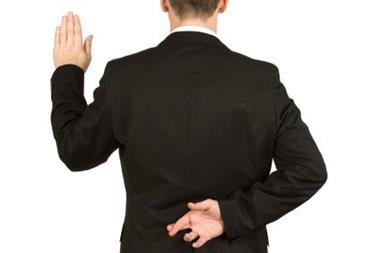 Man swearing an oath but with fingers crosed behind his back