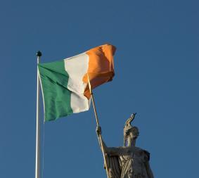 Irish flag above a statue
