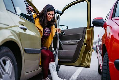 personal injury woman crutches car