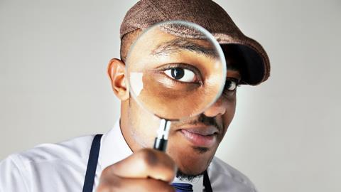 Black man with a magnifying glass