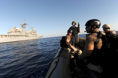 Gulf of Aden: Members of the visit, board, search and seizure team of the guided-missile cruiser USS San Jacinto (CG 56) wait for instructions to resume counter piracy operations.