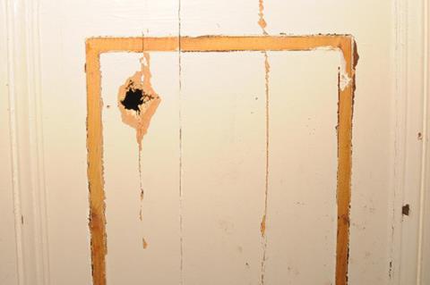 Essex police photo of shotgun damage at insurance executive's home
