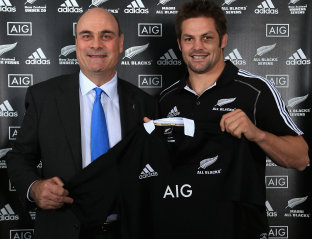 Peter Hancock, chief executive of AIG Property Casualty, and Richie McCaw, captain of the All Blacks, with new AIG All Blacks jersey.