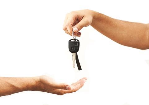 Hands giving motor car keys